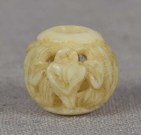 19c OJIME netsuke slide IRISES: 19th century small ojime (slide bead for tightening the cord going from netsuke to inro) carved in the round with a pierced design of blooming irises. Wonderful carving, excellent detailing, pleasant