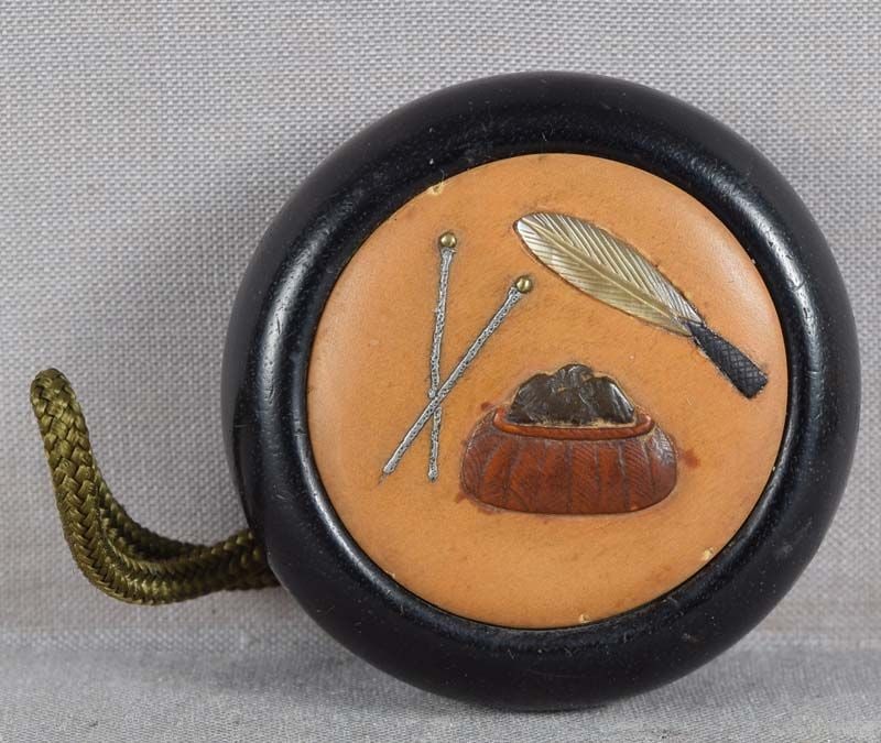 19c netsuke Shibayama TEA CEREMONY utensils: 19th century kagamibuta (mirror lid) netsuke with Shibayama inlay depicting 3 utensils for tea ceremony: haboki (feather brush for ashes), sumitori (charcoal basket) and hibashi (fire tongues).