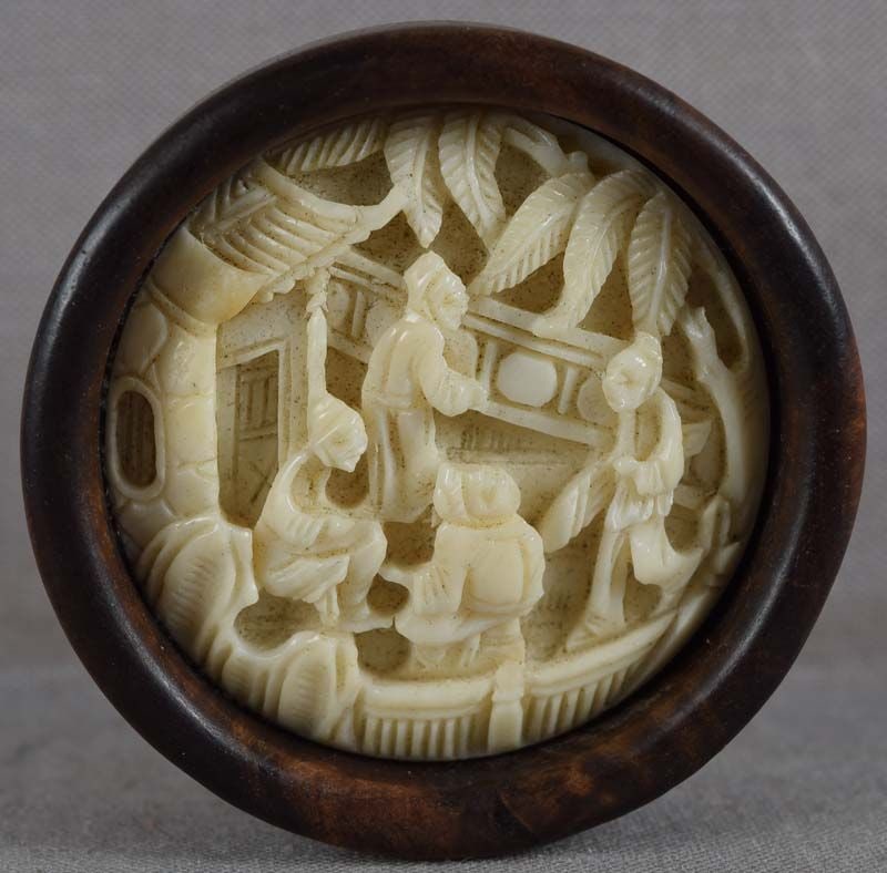 19c netsuke SCHOLARS in garden: 19th century kagamibuta (mirror lid) netsuke, the top being Chinese carving adopted as netsuke, with deeply undercarved scene of 4 scholars among trees and pavilions. Wonderful crisp carving, great we