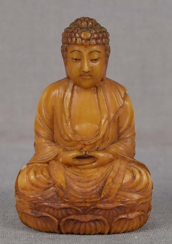 19c netsuke AMIDA BUDDHA: 19th century netsuke carved as Amida Buddha sitting with his hands in jo-in mudra - hand gesture signifying concentration. Amida (Amitabha) - "The Buddha of Immeasurable Light and Life” - is the