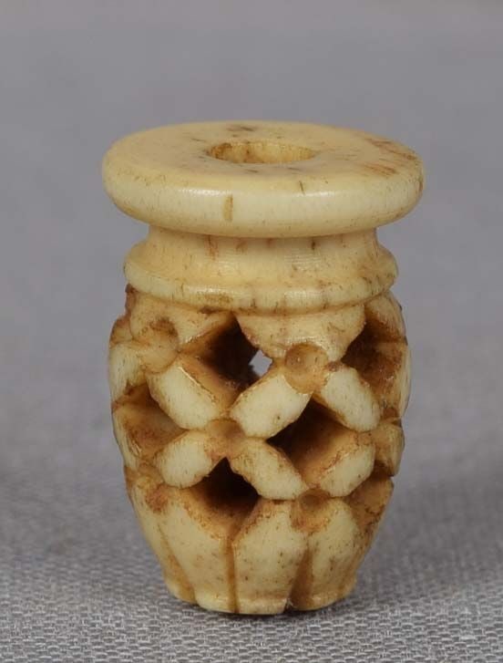 19c staghorn OJIME netsuke slide SAKE JAR: 19th century staghorn ojime (slide bead for tightening the cord going from netsuke to inro) carved in a shape of a ceramic sake jar with high shoulders and wide top, pierced and decorated with geometr