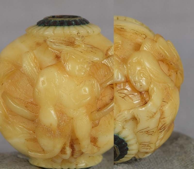 19c marine OJIME netsuke slide YABUSAME ARCHER & maiden: 19th century marine material ojime (slide bead for tightening the cord going from netsuke to inro) in ball shape carved in medium relief with a kneeling maid presenting a gift to a standing samurai ar