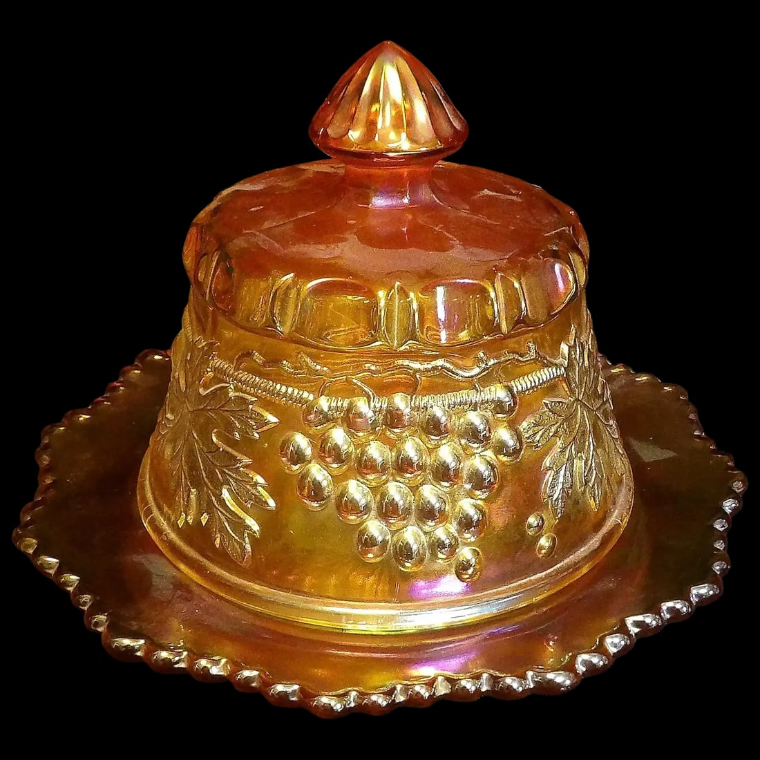 Antique Northwood Grape and Cable Butter Dish: This Antique Northwood Grape and Cable Butter Dish is in excellent condition. NO chips, stains or flea bites. It measures Width: 7 1/2 in X Height: 6 in. It is Pressed Carnival Glass. If you collect