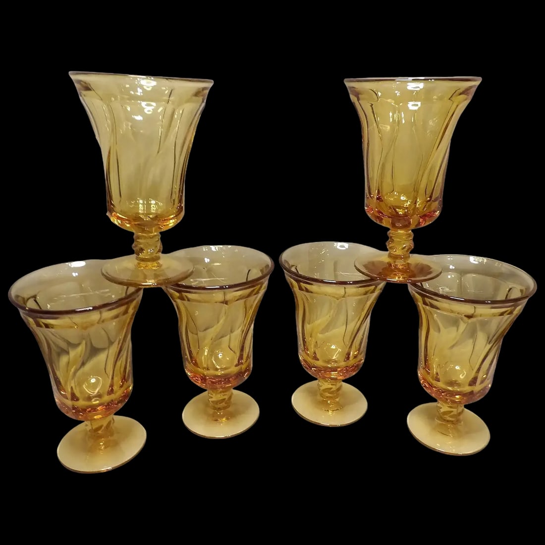 Set of Six Fostoria Jamestown Amber Ice Tea Glasses: These six Fostoria Jamestown Amber Ice Tea Glasses have the classic swirl pattern which accentuates the depth of color. "Jamestown" was introduced in 1958. Research on some sites say it was produced