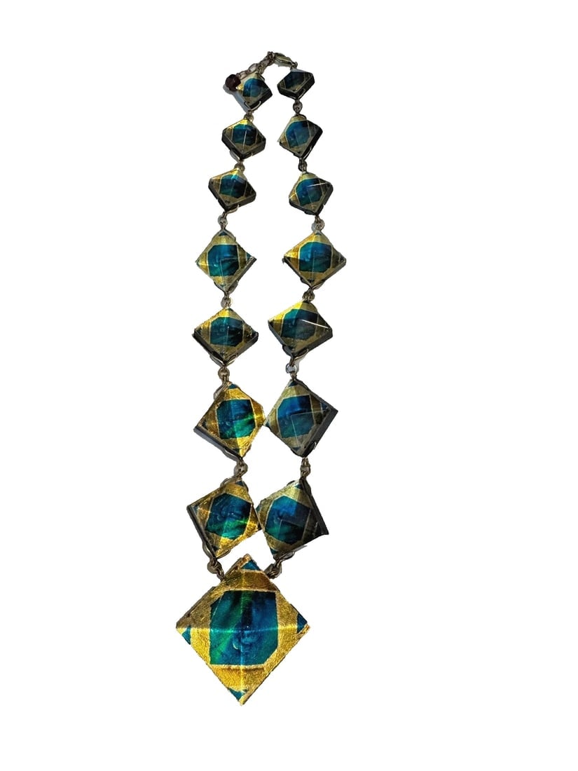 Signed MMA Metropolitan Museum Tiffany Mosaic Collection Lucite Necklace: The product is a stunning necklace featuring a mosaic design created by the Metropolitan Museum of Art. The necklace is made of Lucite material and showcases a multicolor pattern, making it a bold