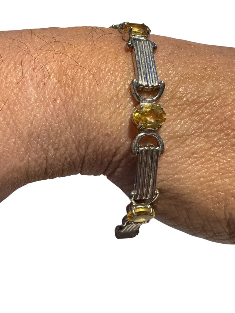 925 Sterling Silver And citrine Topaz Bracelet 7 Inch 12 Grams: This 925 Sterling Silver and Citrine Topaz Bracelet features a seven-inch length with a spring ring closure. The tennis style bracelet is adorned with three citrine stones, each measuring approximatel