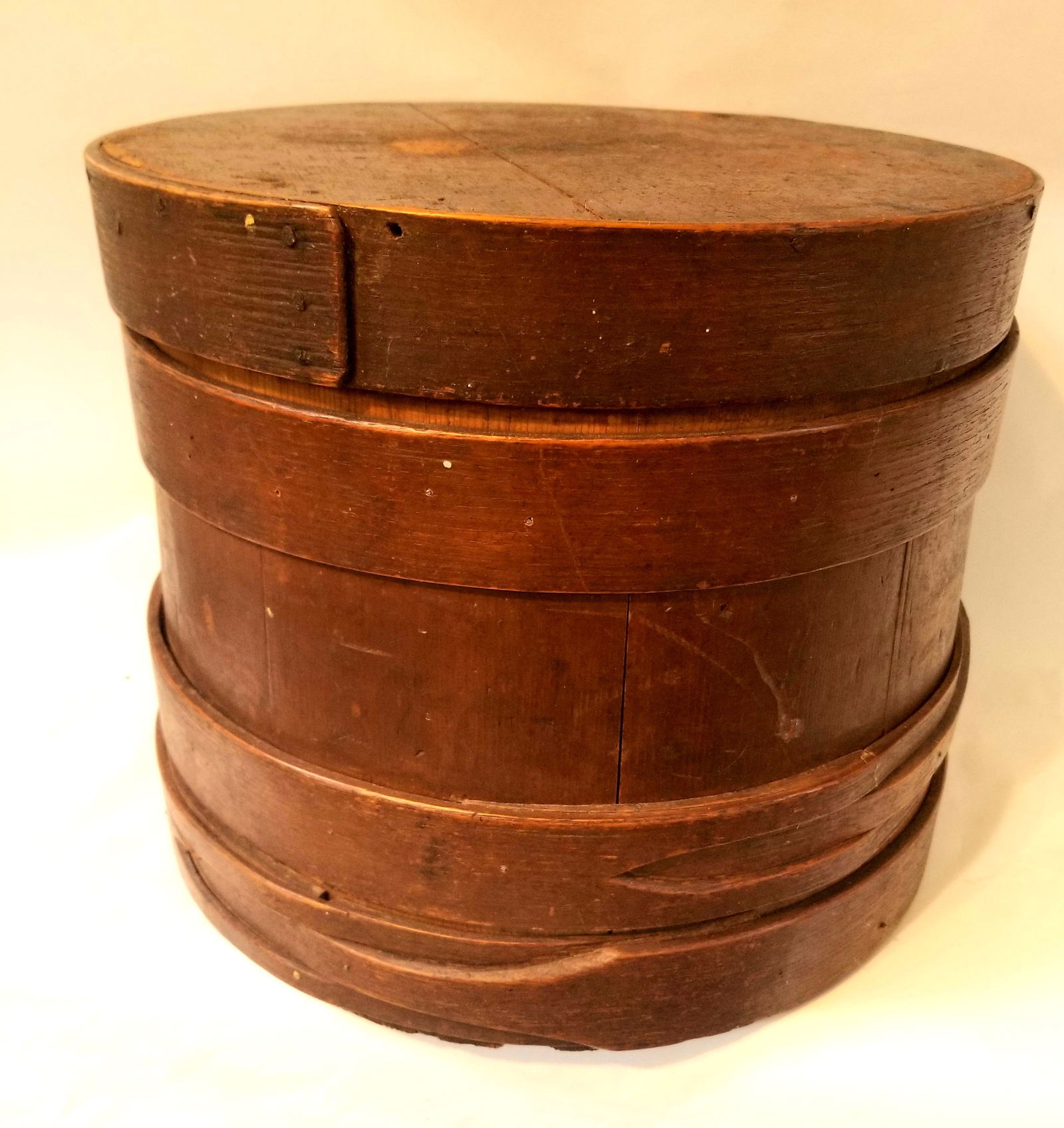 Handleless firkin with buttonhole staves: Original brown painted surface. New England c. 1840. Excellent condition. 10" high 12" wide. Shipping:Domestic: Flat-rate of $20.00 to anywhere within the contiguous