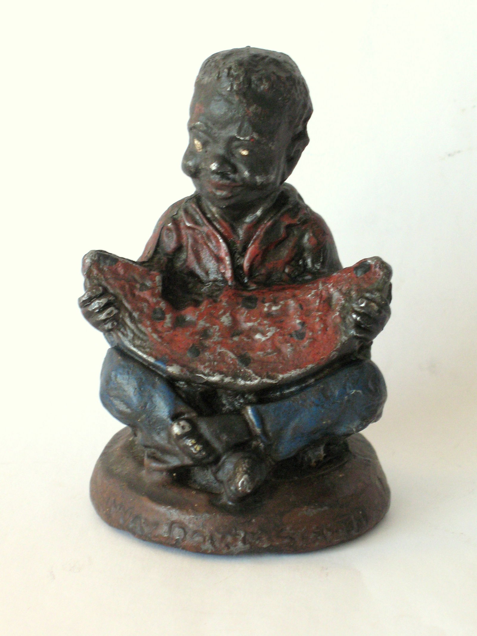 Antique cast lead black boy with watermelon paper weight. (1 of 6)