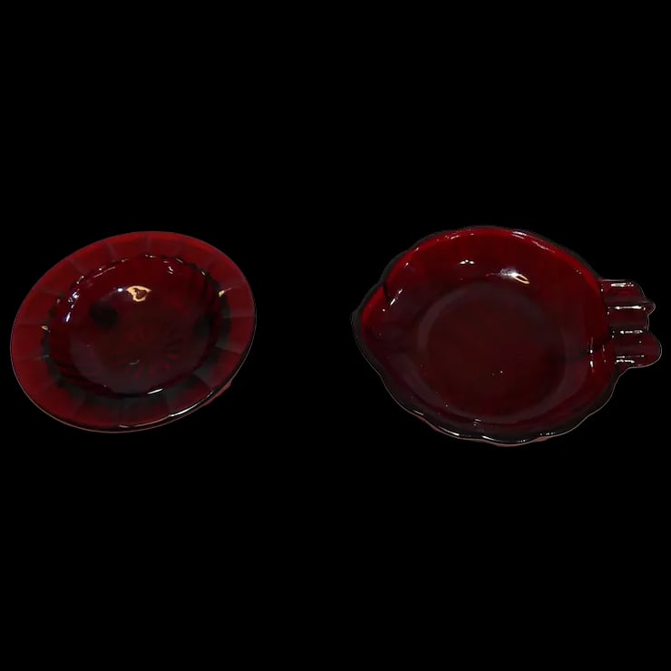 Anchor Hocking Royal Ruby Leaf Shaped & Footed Ashtray: This pair of Anchor Hocking Royal Ruby Leaf Shaped & Footed Ashtrays are in excellent condition. The leaf shaped onemeasures 5” x 4 ½”, and the footed one measures 4” x 1”