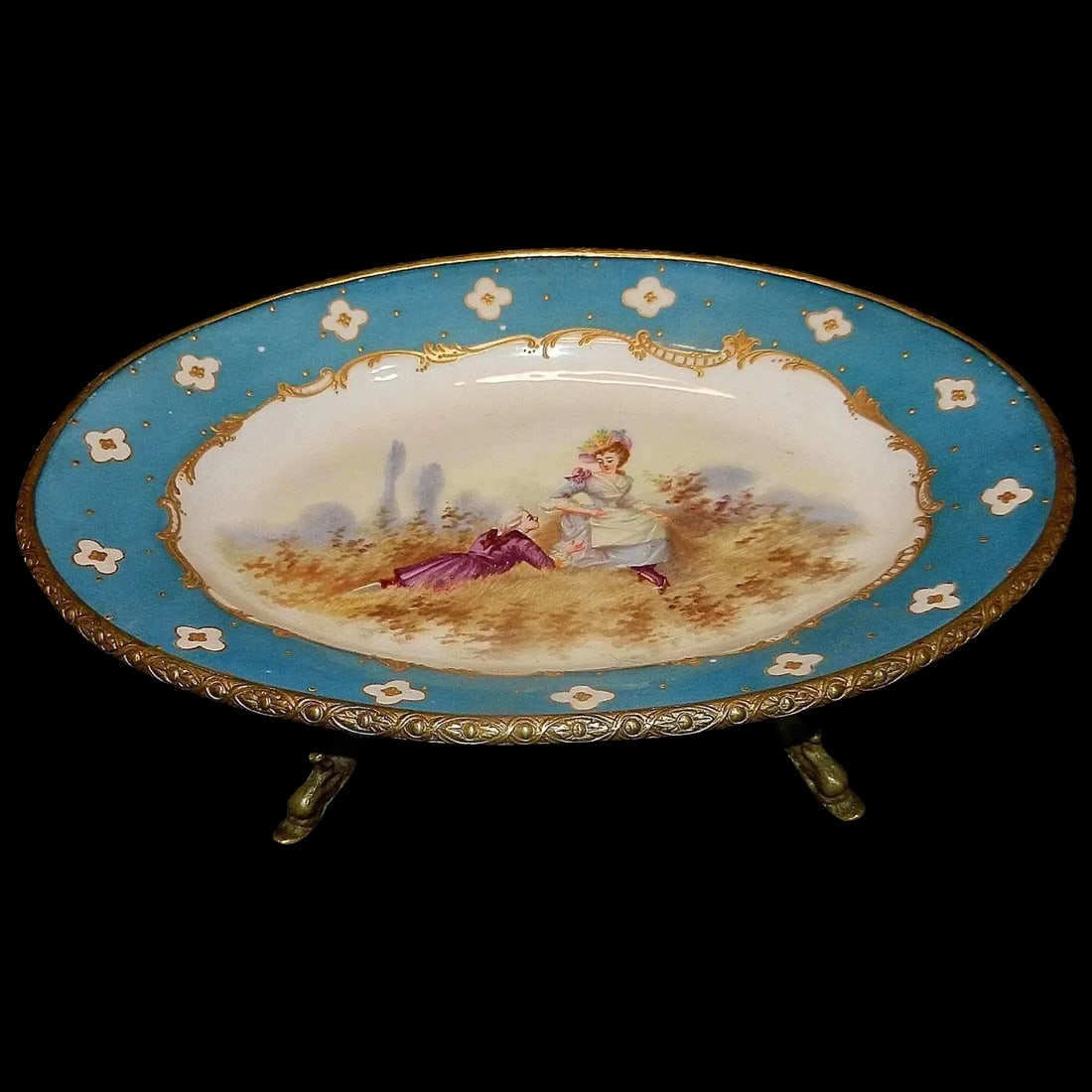 Antique Victorian Hand Painted Porcelain Plate with Ormolu Trim Serves Style: There are just no words to really describe this Antique Victorian Hand Painted Porcelain Plate with Ormolu Trim and Dolphin Footed Base. The plate is adorned with a charming couple mounted in