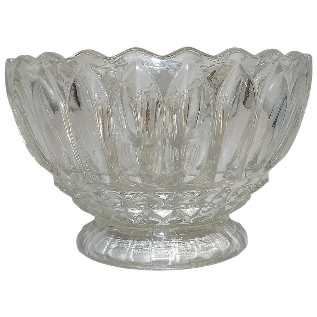 Vintage Indiana Glass 'Lotus Blossom' Bowl: Scalloped Edge, Diamond Detail: Elevate your dining experience with the timeless beauty of the "Lotus Blossom Clear Footed Cupped Bowl" crafted by INDIANA GLASS. This discontinued piece showcases exquisite craftsmanship and