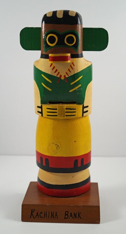 Totem Pole Doll Wooden Still Bank #6: Title: Totem Pole Doll Wooden Still Bank #6Dimension: 11 ¾” tall x 5” wide x 3 3/8” deepDate: Ca. 1940’s – early 50’s.Additional Information: Exceptional