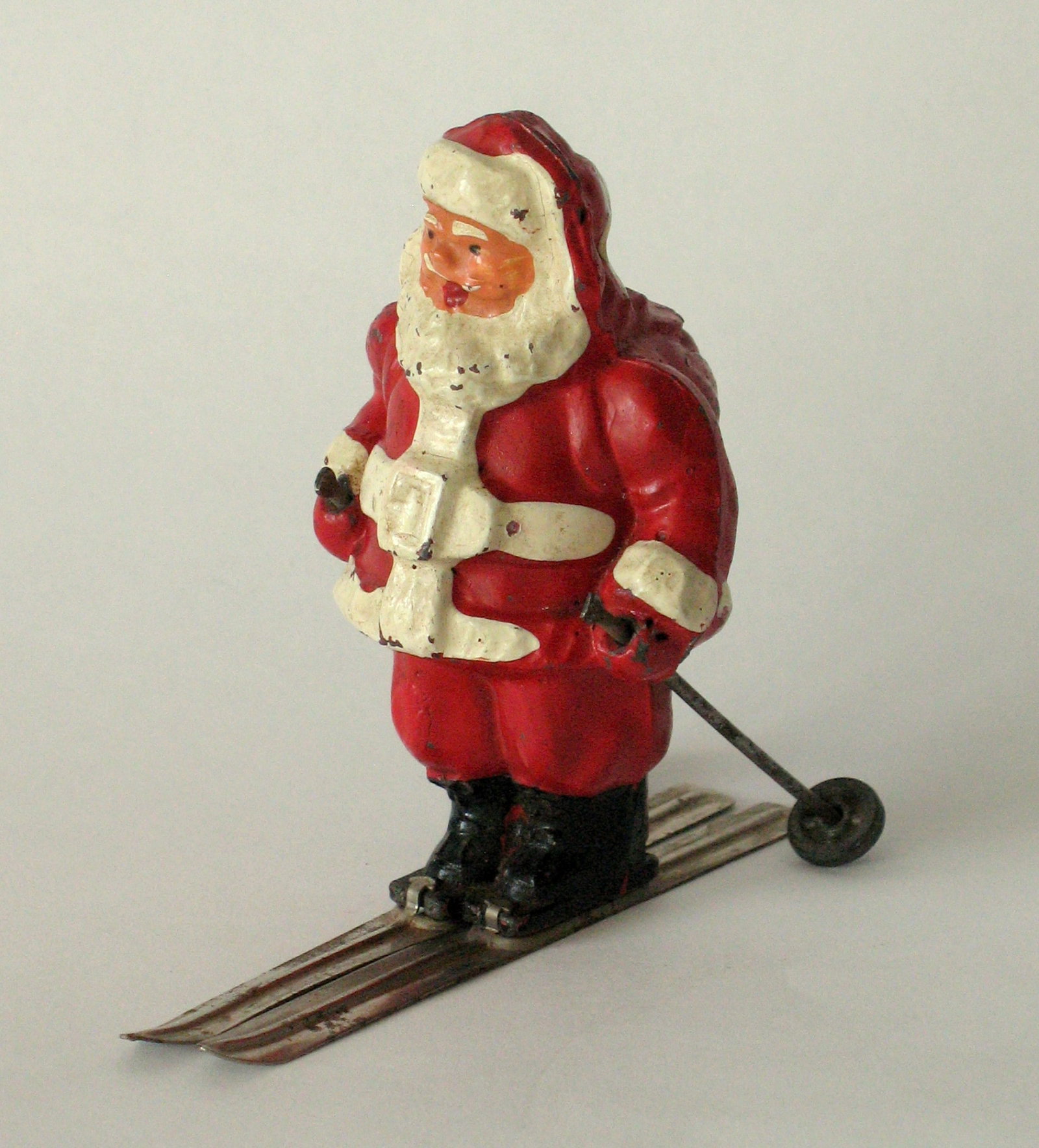 Antique cast metal Santa on skies paper weight. (1 of 4)