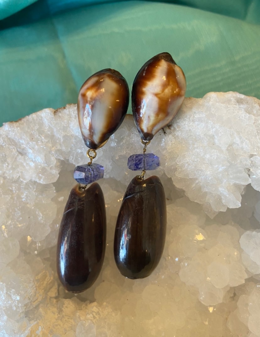 Amethyst & Olive Shell Earrings: Title:Amethyst & Olive Shell Earrings Description:These wonderful cat-eye Cyprea, rutilated Amethyst and black Olive shell earrings are surely showstopping. Vermiel peirced omega clip. Drop 3 1/3" Res