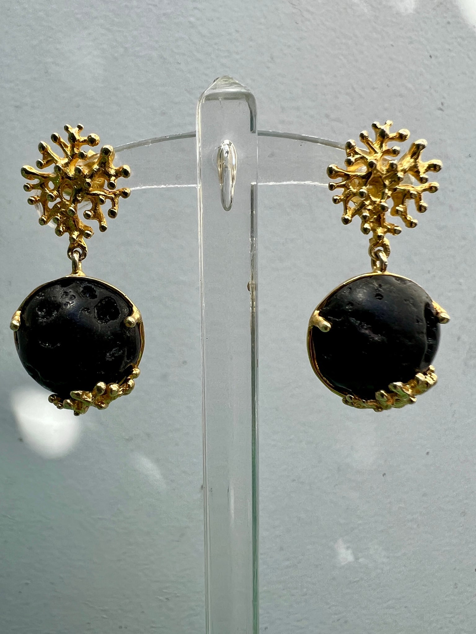 Hawaiian Lava Rock Earrings: Title:Hawaiian Lava Rock EarringsDescription:Hawaiian Lava Rock earrings seated in a bed of vermeil coral shapes that reach over the lava stone - for pierced ears. Reserve: $120.00 