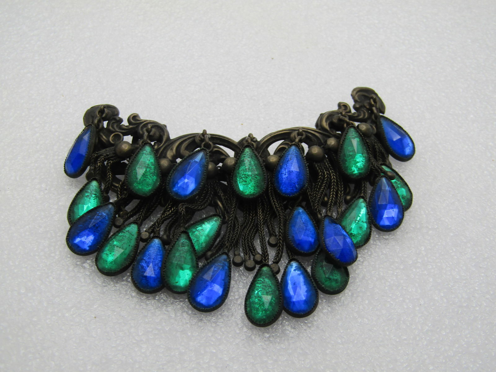 Antique Dress Clip with Dangles, 3.5" Wide, Blue/Green Glass Dangles: Title:Antique Dress Clip with Dangles, 3.5" Wide, Blue/Green Glass DanglesDescription:Antique Dress Clip with Dangles, 3.5" Wide, Blue/Green Glass Dangles. I have not found a match to this dress
