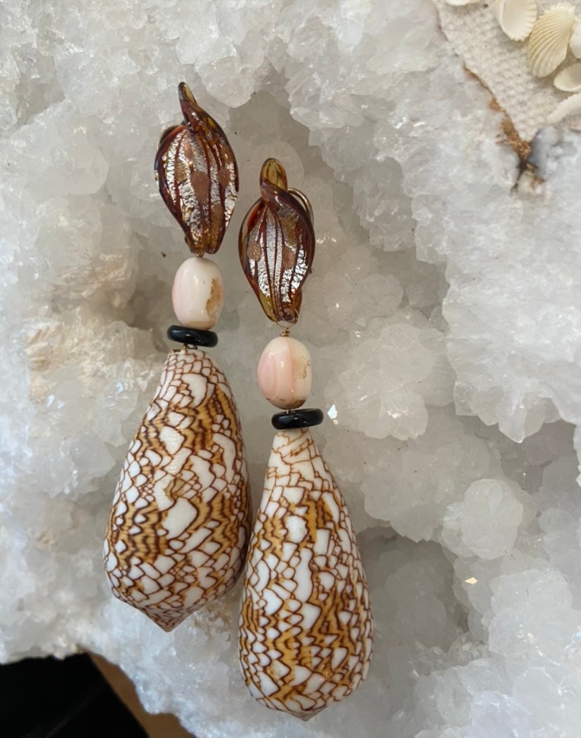 Venetian Glass Earrings: Title:Venetian Glass Earrings Description:Venetian glass tops with cut conch shell beads, Onyx rings and Conus. Sterling silver clips. 4" drop Reserve: $140.00 Shipping: Domestic: Shipping rates are d