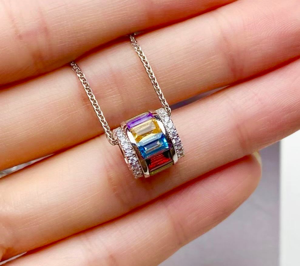 S925 silver natural crystal pendant: Title: S925 silver natural crystal pendant Description: This pendant showcases the colorful hues of natural crystals, exquisitely set in S925 silver. The craftsmanship highlights the deep purple of