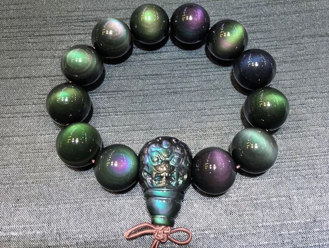 Natural Obsidian Bracelet: Title: Natural Obsidian Bracelet Description: This bracelet showcases the enchanting beauty of natural dual-color obsidian, with each bead emitting a unique color spectrum. The 16mm beads are perfectl