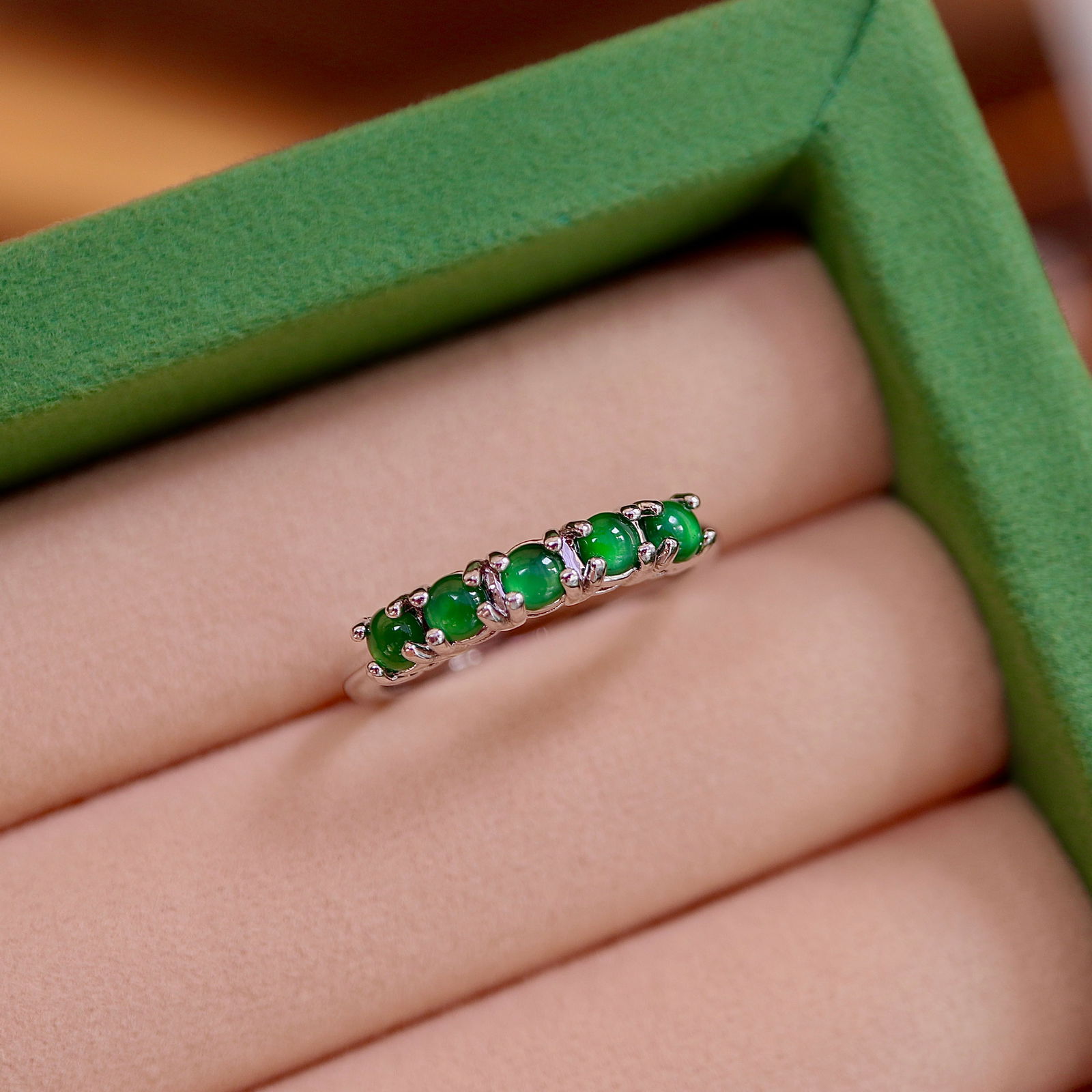 Natural Jade Ring: Title: Natural Jade Ring Description: This ring is set with five natural jade stones, symbolizing the arrival of good fortune. The jade's green luster complements the simple yet exquisite design, maki