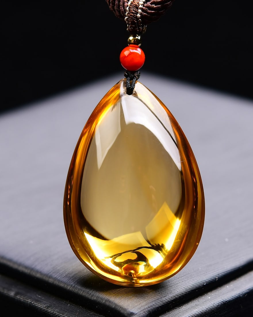 Natural yellow crystal water drop pendant: Title: Natural yellow crystal water drop pendant Description: This pendant showcases captivating natural yellow crystal, presenting a charming teardrop shape. The gemstone emits a warm golden light,