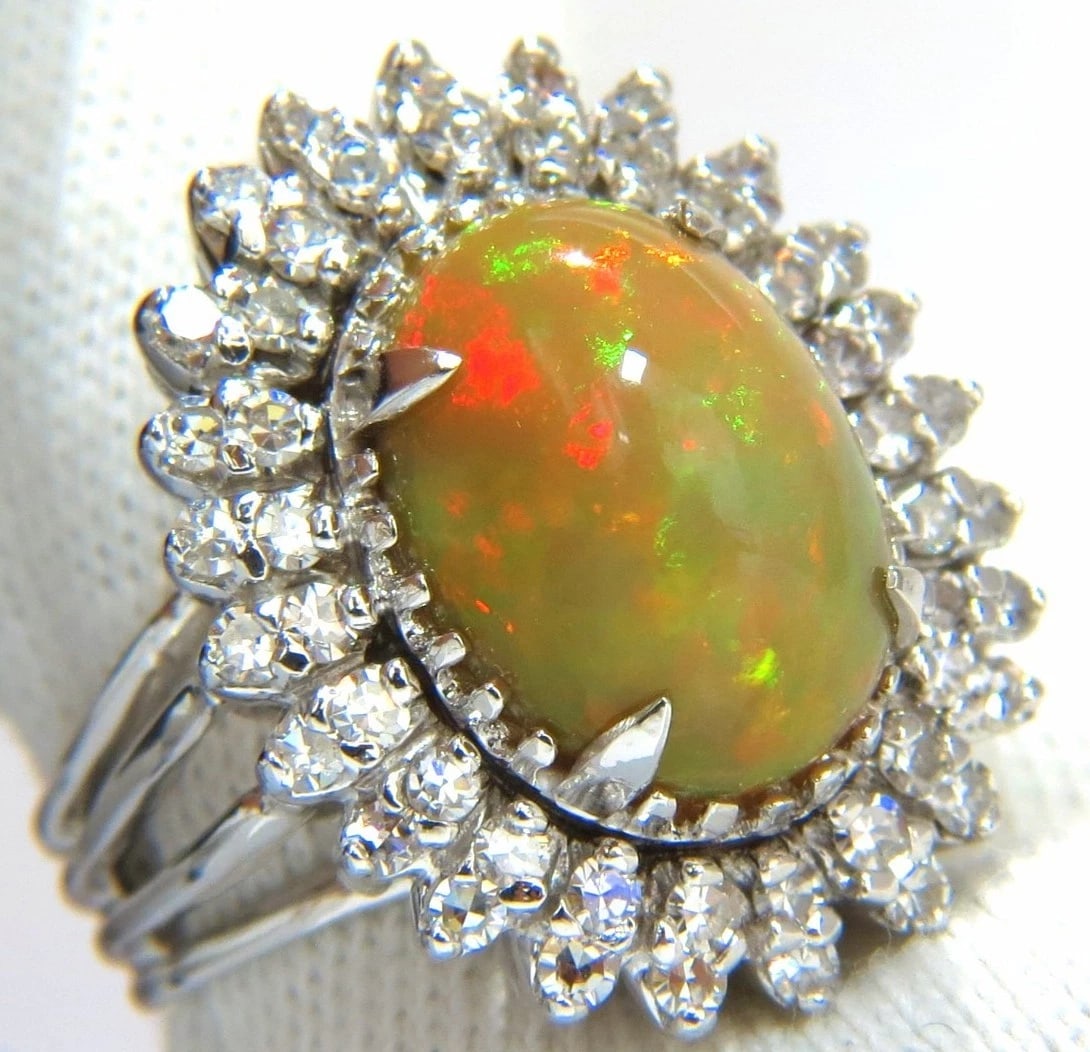 GIA 7.17ct natural cabochon opal diamonds sunburst cocktail ring 14kt.+: Title: GIA 7.17ct natural cabochon opal diamonds sunburst cocktail ring 14kt.+ Description: Play of color. GIA Certified 5.97ct. Natural Non treated Opal ring. Report: 2145457599 Oval cut: 14.80 X