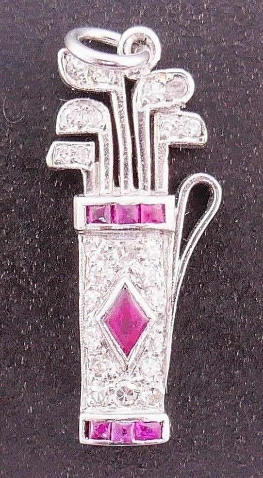 Platinum Diamond Ruby Charm: Title: Platinum Diamond Ruby Charm Description: Platinum Golf Bag charm features ruby and diamonMeasurements: Length is 7/8 inches, a widest part is 1/4 inches Weight is 2.3 grams In excellent conditi