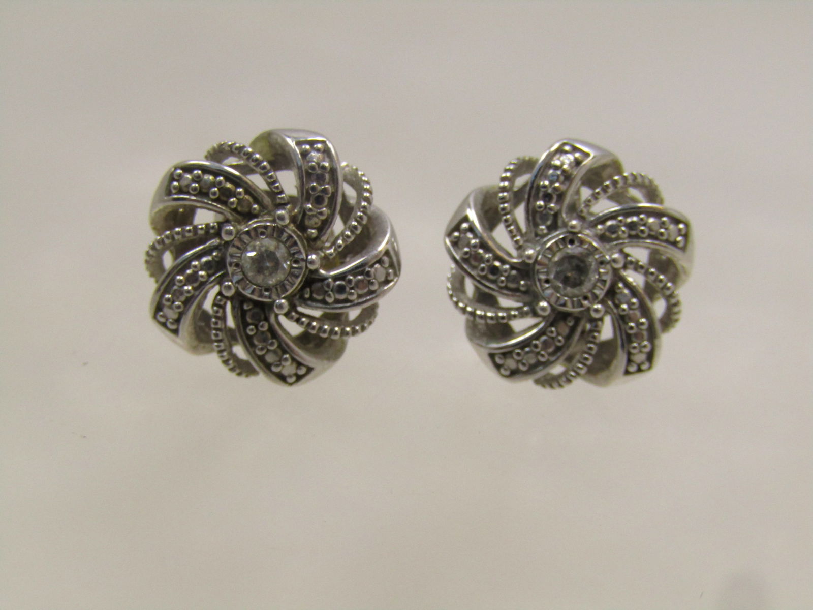 Sterling Diamond Spiral Stud Earrings, 1980's, Signed SK9: Sterling Diamond Spiral Stud Earrings, 1980's, Signed S. These area spiral nest-like round design that is appx. 12mm wide with a center, slightly raised 2mm diamond. The spiral bands that surround