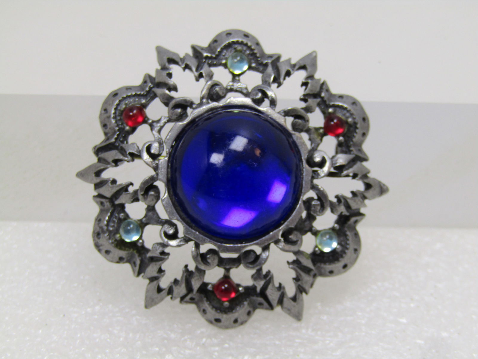 Vintage Rhinestone Leaf Domed Brooch, 1970's-1980's: Vintage Rhinestone Leaf Domed Brooch, 1970's-1980's. This has a look, to me, like something out of Lord of the Rhings. It is a round domed silver tone jagged leaf brooch with open work and scalloped d