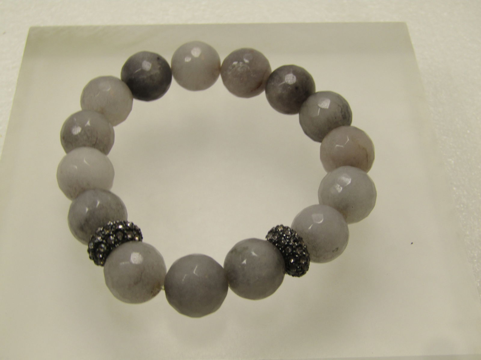 Gray Faceted Quartz Bracelet, Stretch with Rhinestone Rondelles, 1990's: Gray Faceted Quartz Bracelet, Stretch with Rhinestone Rondelles, 1990's. The faceted and rondelles are appx. 11.5mm . iT IS 6.75" at rest - can be stretched up to about 7.25" but would not push it