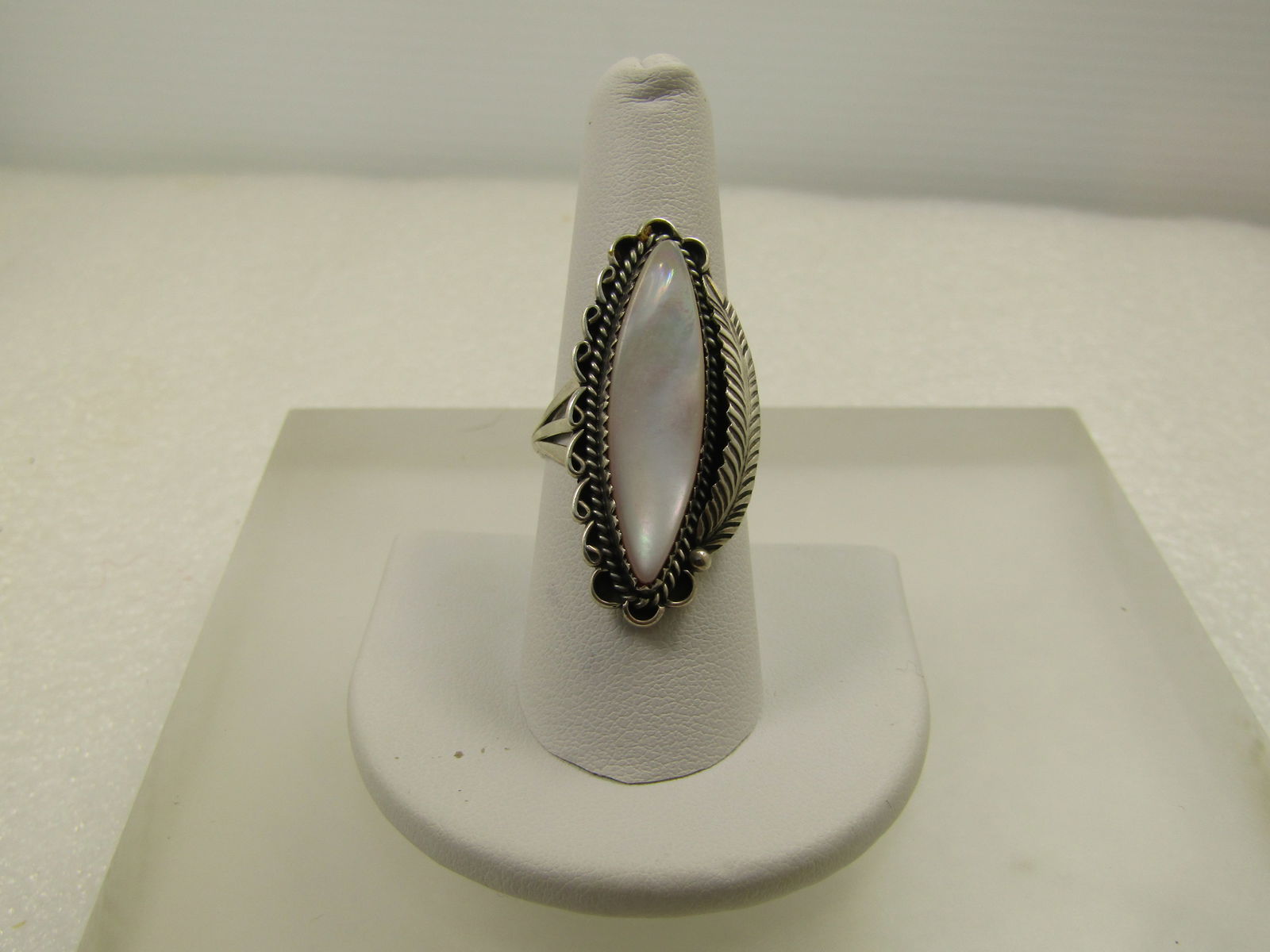 Vintage Sterling Southwestern Mother-of-Pearl Ring, Size 8.5, 1970's: Vintage Sterling Southwestern Mother-of-Pearl Ring, Size 8.5, 1970's. Pale Pink MOP cabochon that is elongated and pointed at appx. 30mm long and 9mm wide setin a sawtooth bezel raised from the