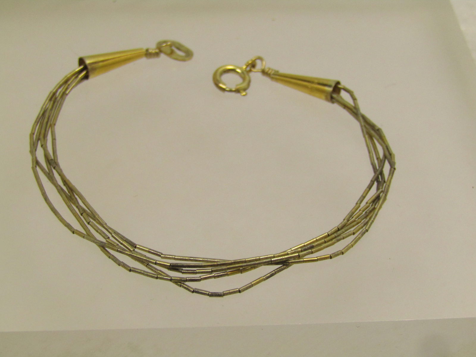 Vintage Sterling Vermeil Southwestern Bracelet, Liquid Silver Five Strand, 1980's: Vintage Sterling Vermeil Southwestern Bracelet, 7.25". Liquid Silver Five Strand, 1980's. Age is estimated at 1980's. This has a gold tone finish over the silver. This has conical end caps that are