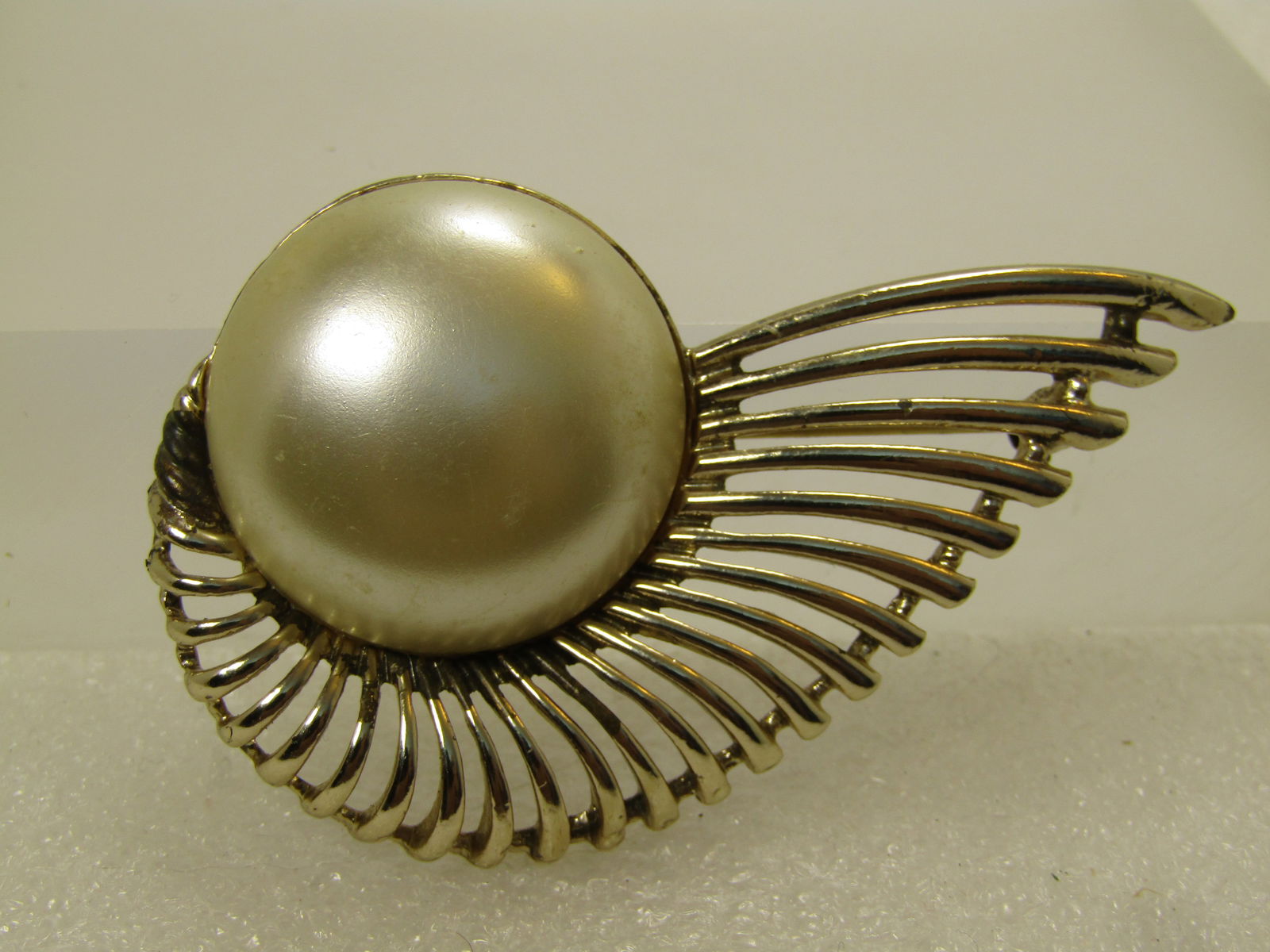 Vintage Faux Pearl Button Brooch, Tapered, Wing-Like Design, 1960's-1970's, SAC: Vintage Faux Pearl Button Brooch, Tapered, Wing-Like Design, 1960's-1970's, SAC. I've seen this listed as Sarah Coventry and I also saw that it was not Sarah Coventry - so unknown who that maker reall