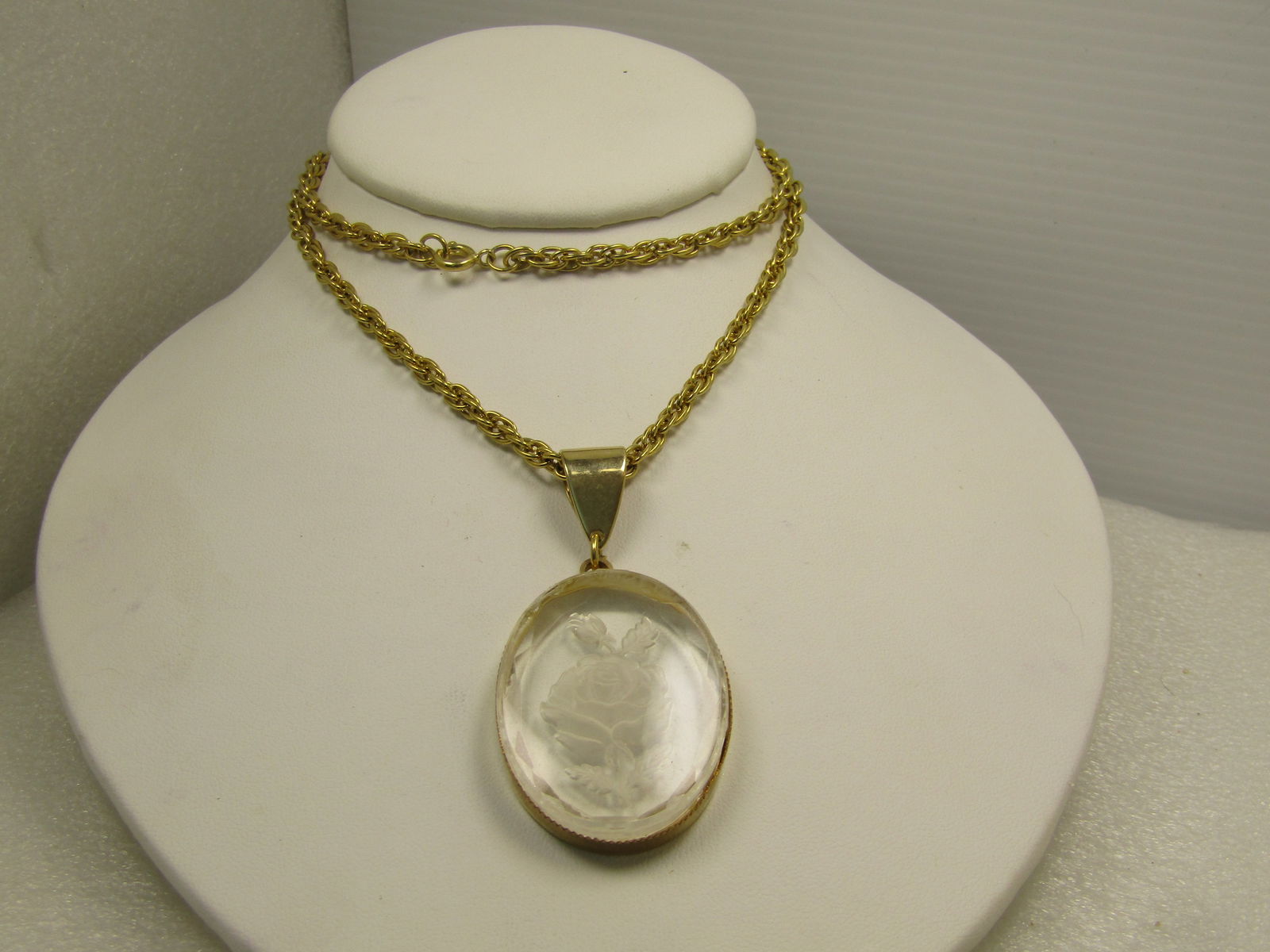 Vintage Lucite Intaglio Rose Cameo Necklace, 24", 1960's-1970's: Vintage Lucite Intaglio Rose Cameo Necklace, 24", 1960's-1970's. Gold tone. The chain is a m ulti-link twisted rope chain that is appx. 3.5mm wide with a twisted rope chain. The pendant has a wide