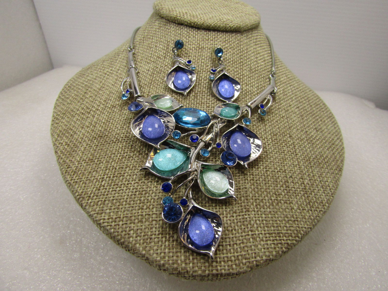 Blossom & Vine Drop Necklace & Earrings Set, Blues/Greens, 20", Pierced, 1990's: Blossom & Vine Drop Necklace & Earrings Set, Blues/Greens, 20", Pierced, 1990's. Silver tone statement necklace with lily like curved blossoms ni mixed sizs with glitter blue and minty green oval ston