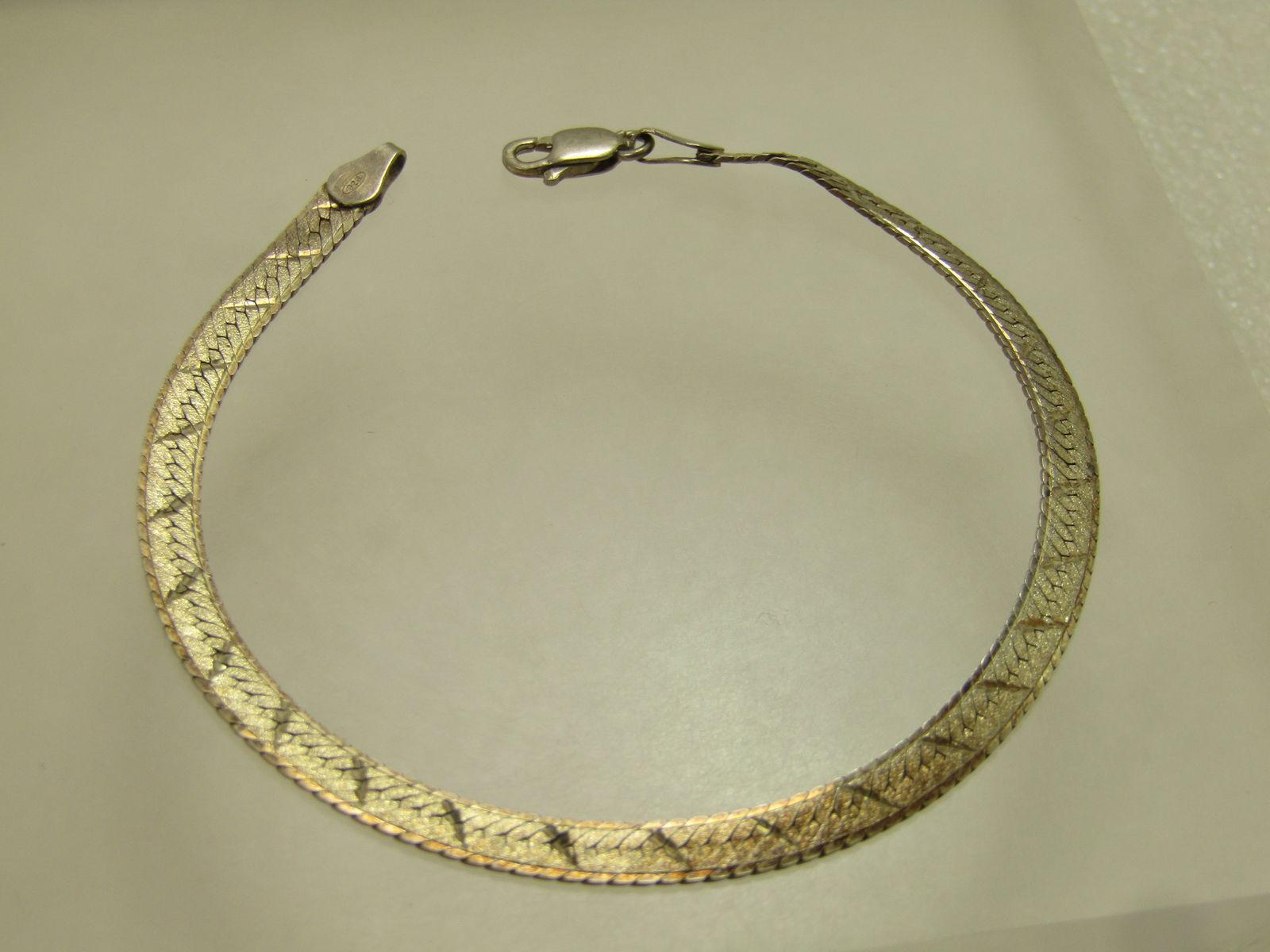 Vintage Sterling Reversible Herringbone Bracelet, 7.25", 1980's, Signed IBB, Unisex: Vintage Sterling Reversible Herringbone Bracelet, 7.25", 1980's, Signed IBB. This is appx. 4mm wide with a textured finish on both sides with a diagonal diamond cut line across the bracelet. 