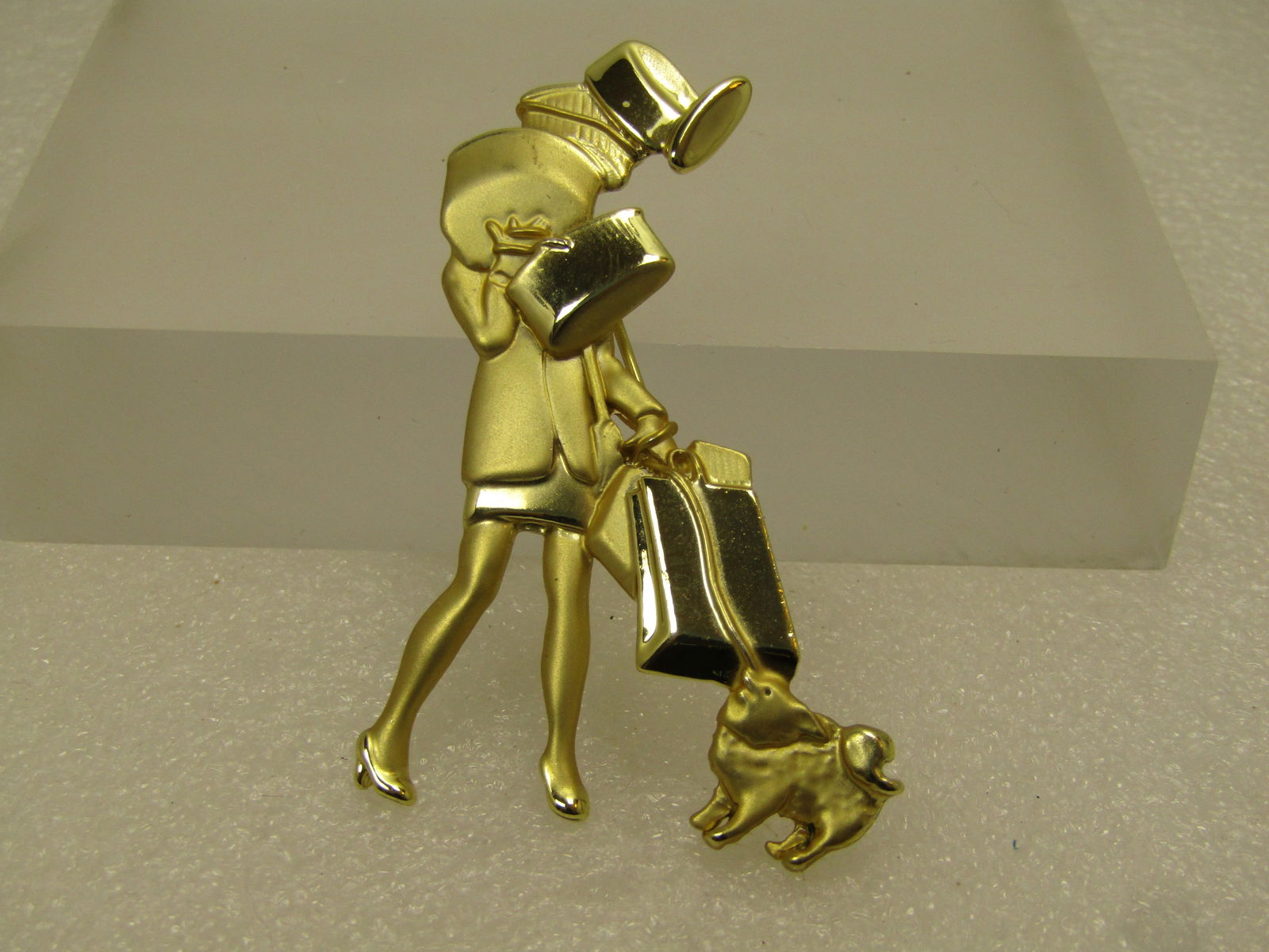 Vintage Woman Shopper with Dog Brooch, Art Deco Themed, 1980's Signed: Vintage Woman Shopper with Dog Brooch, Art Deco Themed, 1980's Signed AJC. It is appx. 2.75" tall and 1.5" wide with both a satiny and smooth and shiny gold tone finish. Very nice quality - very clean
