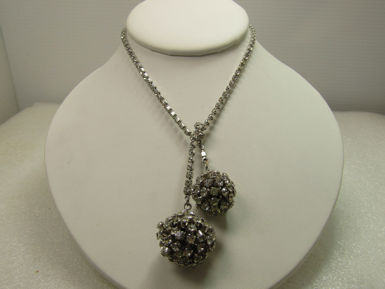 Vintage Clear Rhinestone Orb Dangle Necklace, 26", 1960's: Vintage Clear Rhinestone Orb Dangle Necklace, 26", 1960's. this is an all clear rhienstone necklace - 24" rhinestone closed black silver tone chain with an appx. 1" and 1.25" orb - one on each end. Wo