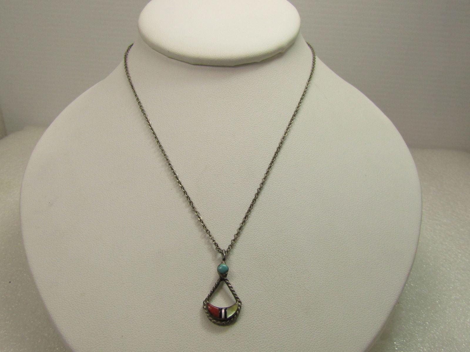 Vintage Sterling Southwestern Inlaid Pendant, 15" Silver Tone Chain, 1960's-1970's: Vintage Sterling Southwestern Inlaid Pendant, 15" Silver Tone Chain, 1960's-1970's. This has a pendant with a round turquoise on top and a curved swing drop design with inlaid mother-of-pearl;