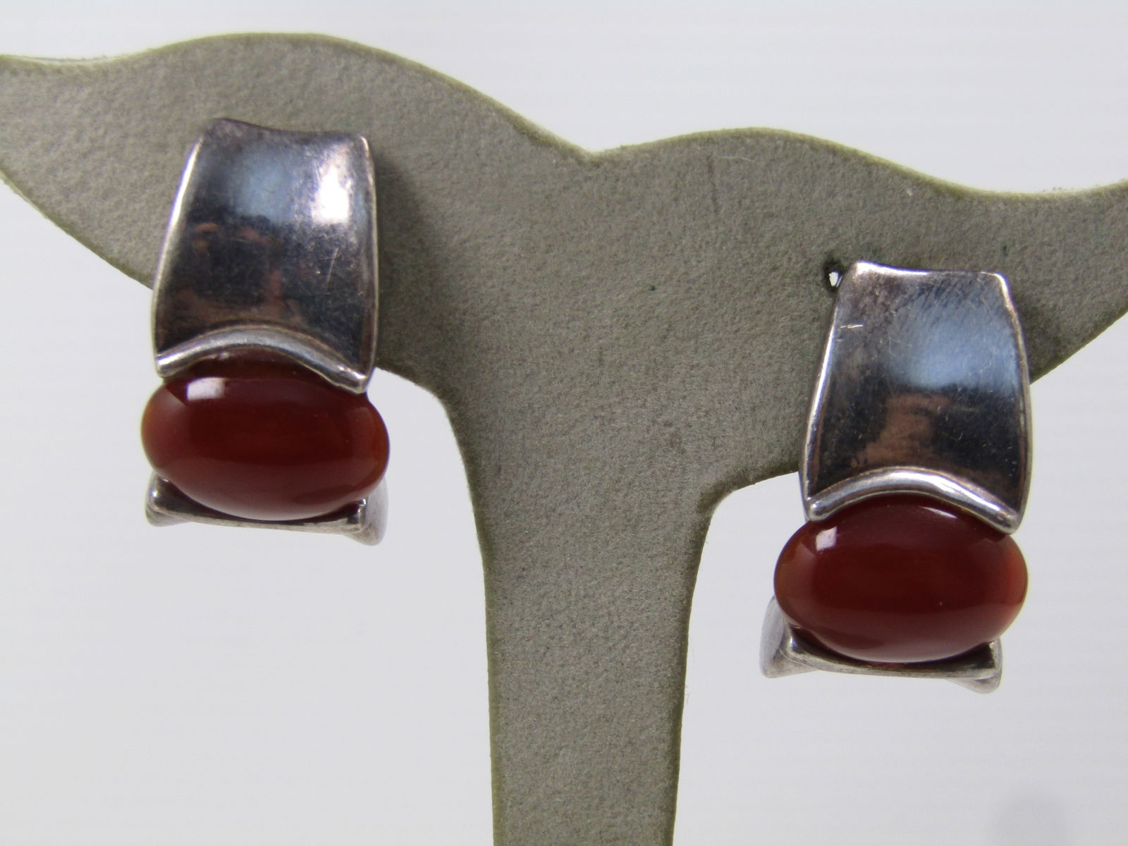 Vintage Sterling Carnielian Clip Earrings, Signed Simon Sebbag, 1980's: Vintage Sterling Carnielian Clip Earrings, Signed Simon Sebbag, 1980's. Modernist design with chunky sterling and a sideways set 17.5mm by 13.5mm carnelian cabochon in the middle. These are appx. 13mm
