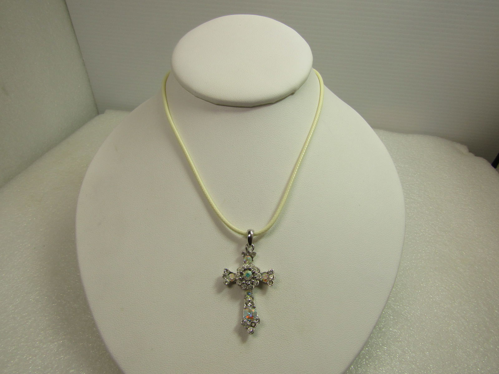 Vintage Aurora Borealis Rhinestone Cross Necklace, 18"-20", 1980's-1990's: Vintage Aurora Borealis Rhinestone Cross Necklace, 18"-20", 1980's-1990's. The cross is silver tone with aurora borealis rhinestones throughout and a tiered blossom center. The the rhinestones are a g