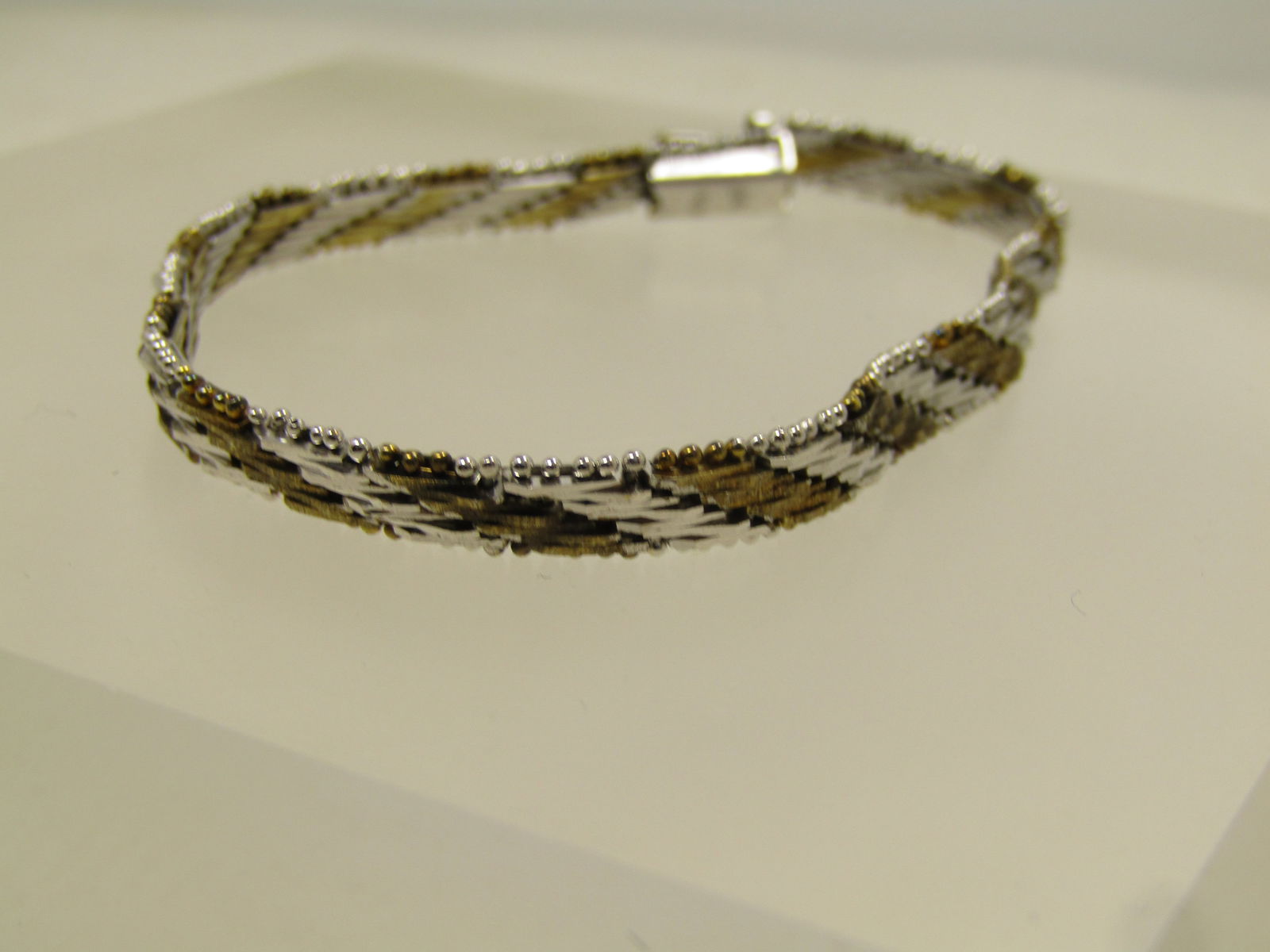 Vintage Silver Plated Two-tone Woven Bracelet,7", 1980's-1990's: Vintage Silver Plated Two-tone Woven Bracelet,7", 1980's-1990's. It is marked .925 but it only tests mildly and then goes away - plated, not sterling. It is also marked Italy. In addition it has a mil