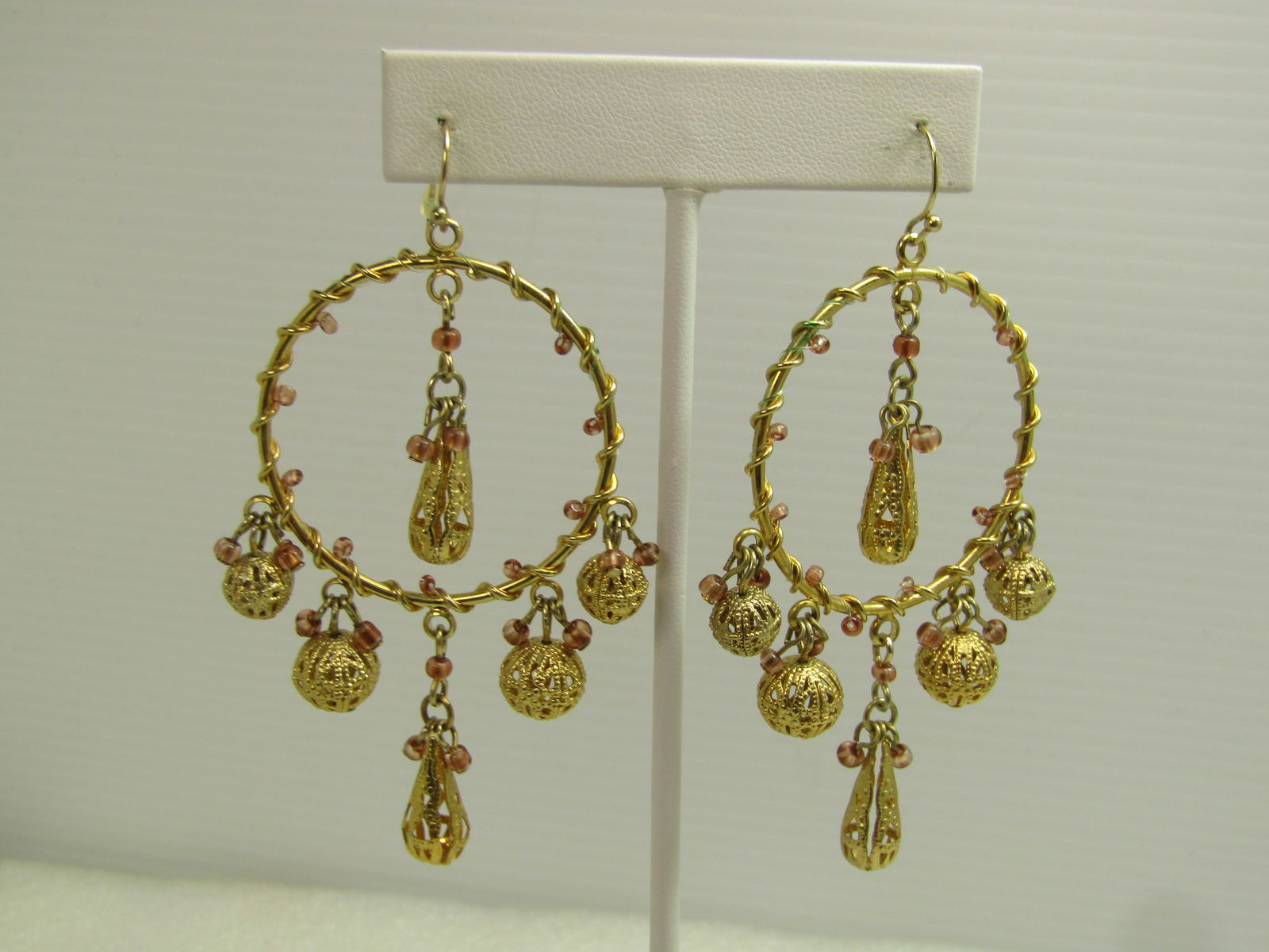 Vintage Filigree Dangle Beaded Hoop Earrings, Pierced, 1980's: Vintage Filigree Dangle Beaded Hoop Earrings, Pierced, 1980's. Gold tone hoops with a wrapped design with graduated round dangling filigree beads and a elongated teardrop at bottom center and in the