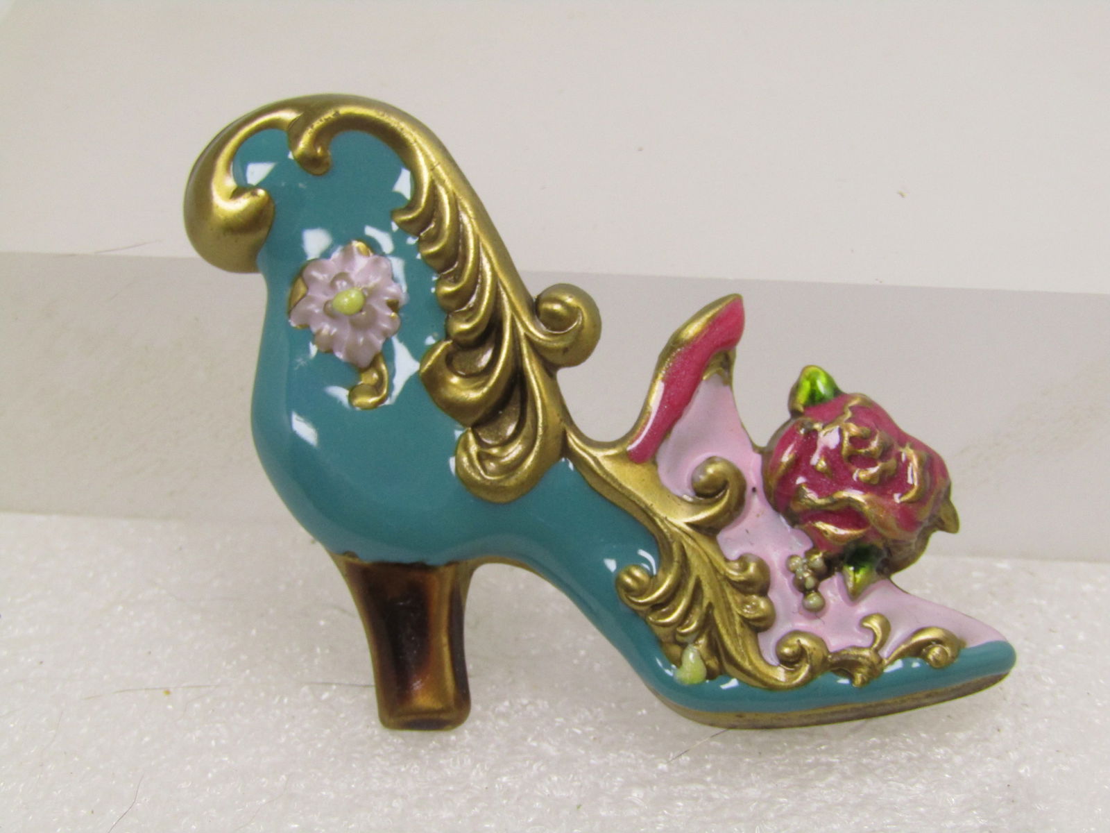Vintage Enameled Victorian Themed Shoe Brooch, 1970's-1980's: Vintage Enameled Victorian Themed Shoe Brooch, Floral Accents. 1970's-1980's. Pressed brassy gold tone metal broochw ith enameling in teal, lavender, pink and also raised exposed brassy gold tone scro