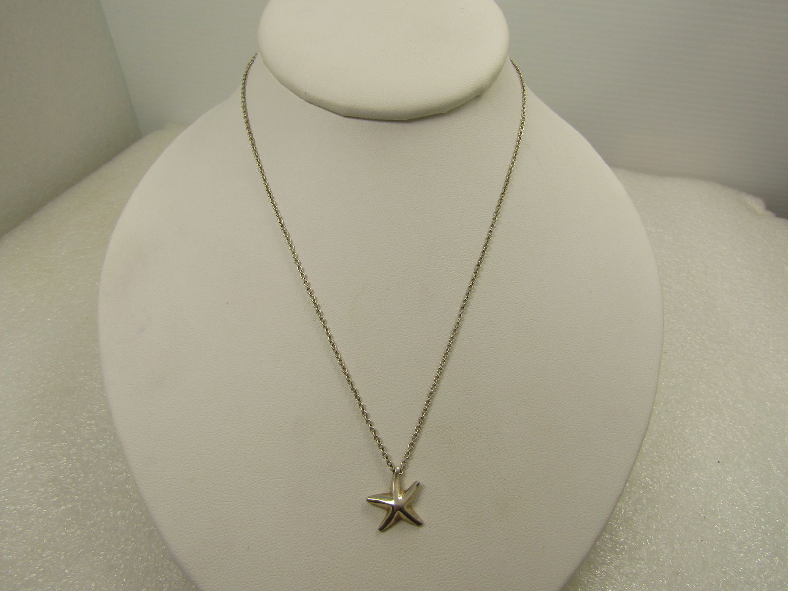 Vintage Silver Tone Star Fish Necklace, 16", 1980's-1990's: Vintage Silver Tone Star Fish Necklace, 16", 1980's-1990's. Costume silver tone necklace with an appx. 5/8" star fish pendant on a 16" silver tone 1mm chain with spring ring clasp. It is marked .925 b