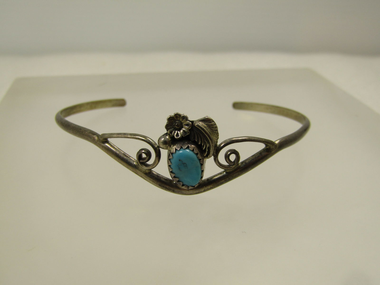Vintage Sterling Southwestern Turquoise Cuff Bracelet, 6" , 1960's-1970's, Signed LM: Vintage Sterling Southwestern Turquoise Cuff Bracelet, 6" , 1960's-1970's, Signed LM. This has a floral, feather, scrolled and silver bead accent on the top of the bracelet. The turquoise, feather,