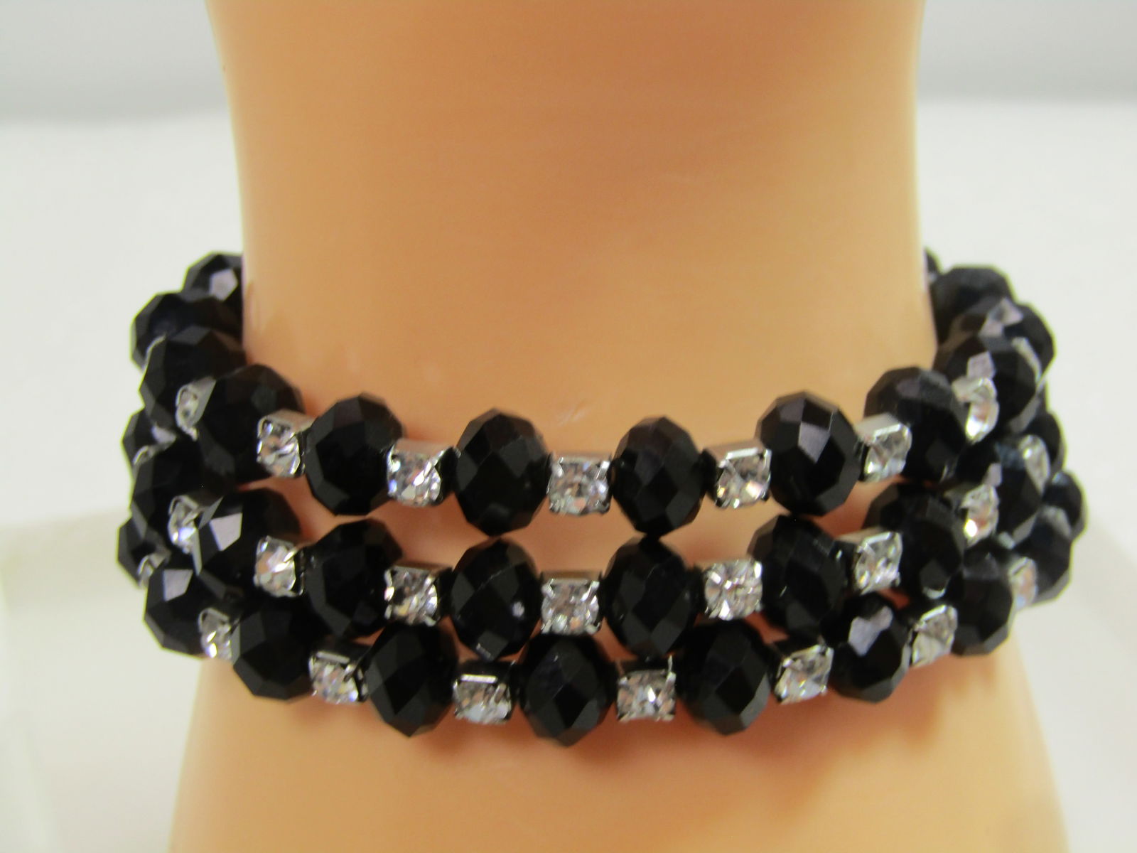 Black Glass & Rhinestone Coiled Bracelet, 1980's-1990's: Black Glass & Rhinestoned Coiled Bracelet, 1980's-1990's. The black glass beads are appx. 8mm rounded and faceted. Between each of the black beads there is a 3mm round clear rhinestone set in a