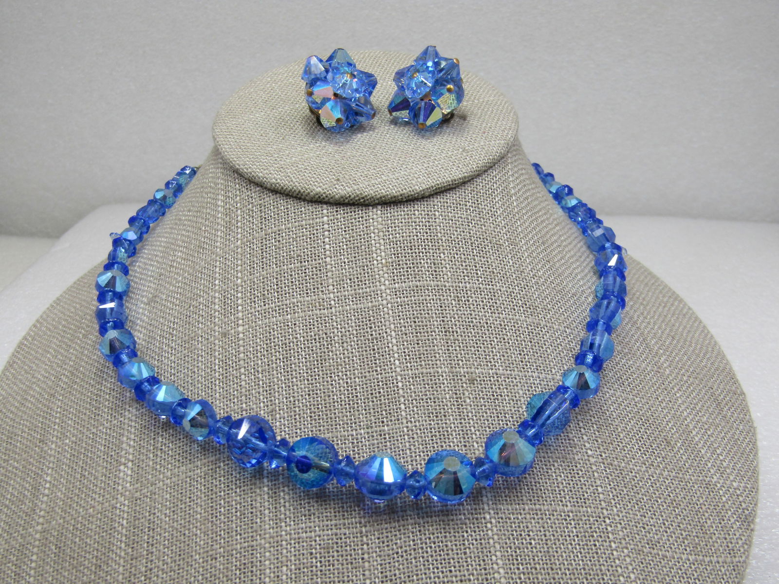 Vintage Blue Aurora Borealis Rhinestone Necklace & Clip Earrings: Vintage Blue Aurora Borealis Rhinestone Necklace & Clip Earrings, 16.5" necklace with hook clasp. Graduated beads from 6mm to 11mm. The rounded beads are interesting because their points are cut with