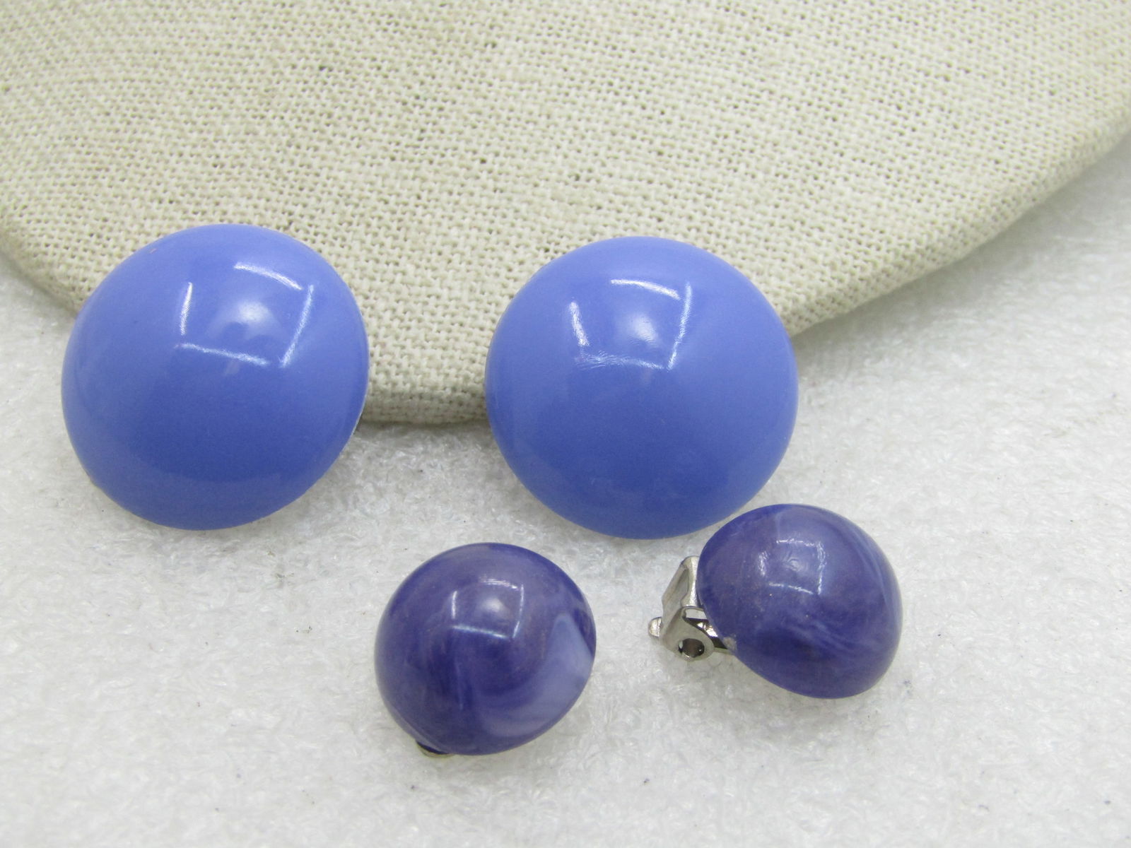 Vintage 2 Pairs Purple Clip Earrings, Round, Mid-Century: Vintage 2 Pairs Purple Clip Earrings, Round, Mid-Century . 5/8" domed round pearly plastic and lavender to purple 1" plastic domed. Good to very good condition, light wear. (INV. KW. SS1002 LD4/2/20)