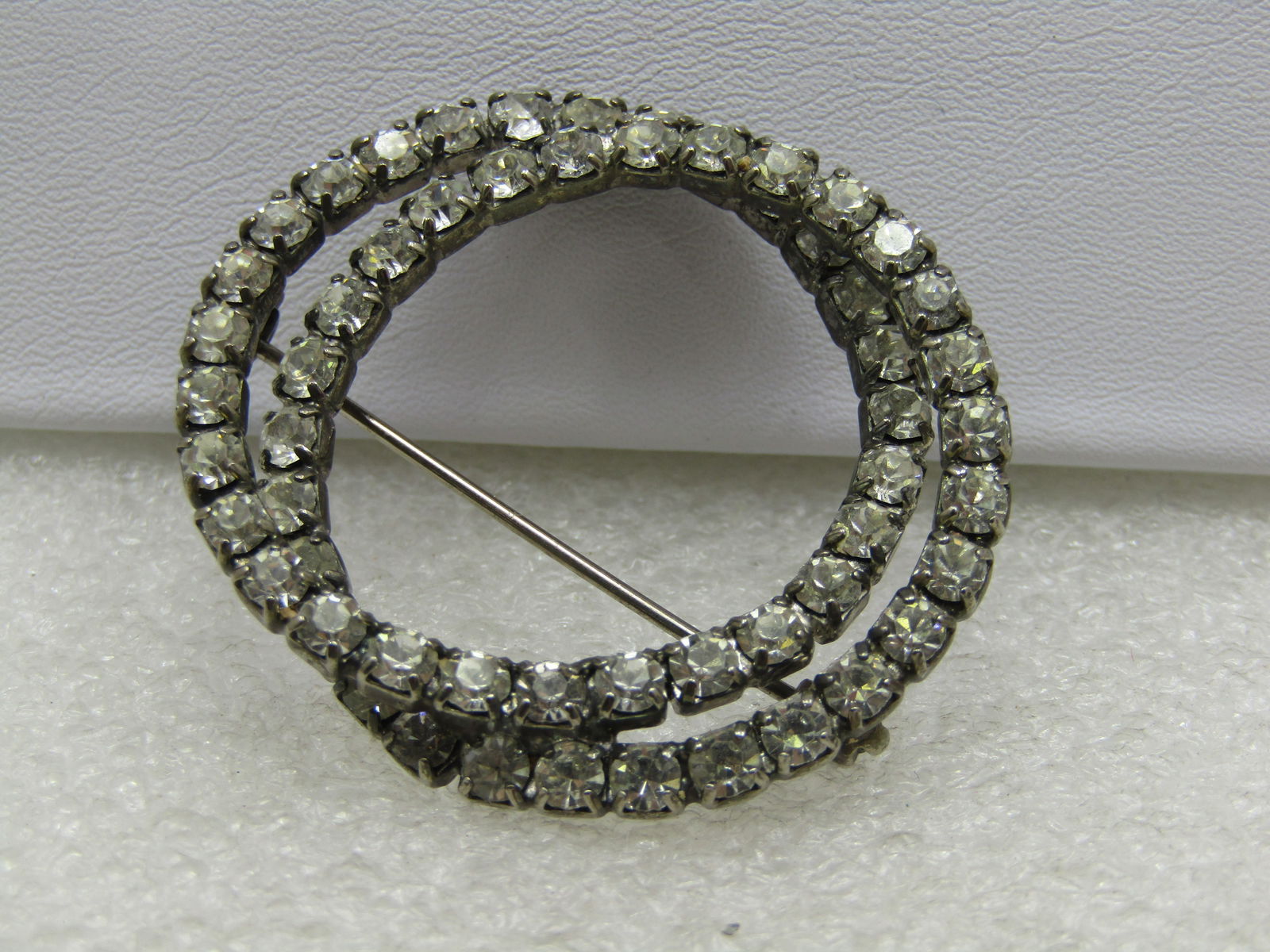 Vintage Double Rhinestone Circle Brooch , 1.5": Vintage Double Rhinestone Circle Brooch , 1.5" - Intertwined. Clear rhinestones, 1960's. Not signed by the maker. Good to very good condition. Reserve: $30.00 Shipping: Domestic: Flat-rate of $6.00 to